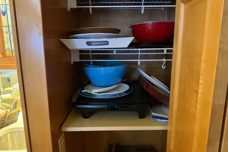Slide: The Image of Kitchen cabinet with assorted bowls and cookware, featuring a Sharpe 80 X 18 model from 2001. - 85