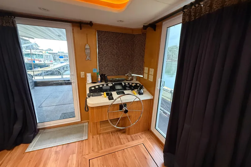 Slide: The Image of Interior of 2001 Sharpe 80 X 18 houseboat helm with wooden flooring and large windows. - 95