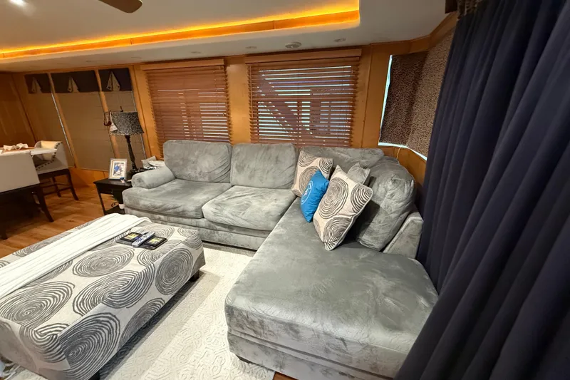 Slide: The Image of Luxurious living room with gray sectional sofa, patterned ottoman, and ambient lighting in a 2001 Sharpe 80 X 18. - 98