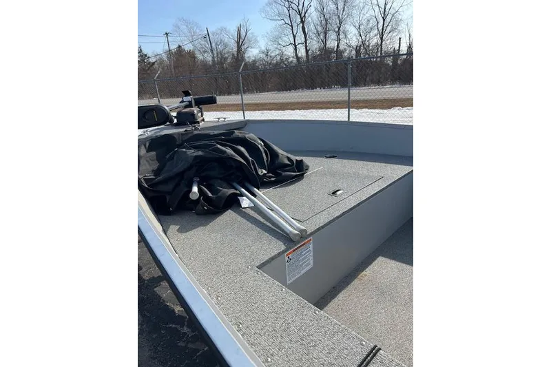 Slide: The Image of 2019 Starcraft Patriot 16 TL boat interior with covered equipment on deck. - 4