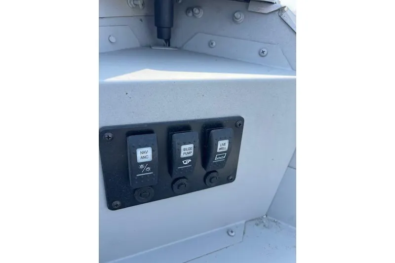 Slide: The Image of Control panel of a 2019 Starcraft Patriot 16 TL boat with switches. - 5