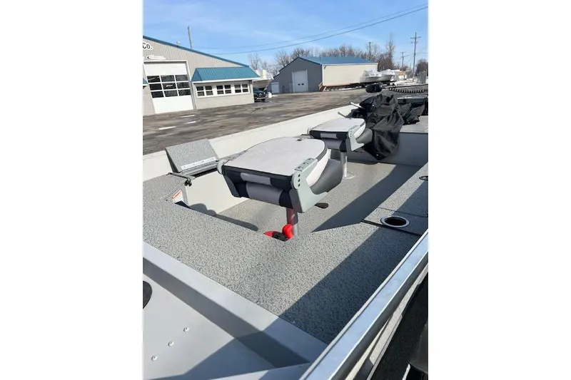 Slide: The Image of 2019 Starcraft Patriot 16 TL boat interior with seating and storage compartments. - 9