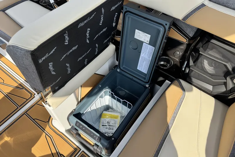 Slide: The Image of 2026 Tigé 24RZX boat interior with open storage compartment and seating. - 21