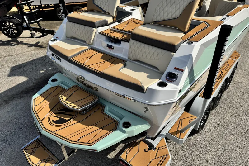 Slide: The Image of 2026 Tigé 24RZX boat with tan and white seating, stylish deck design. - 4
