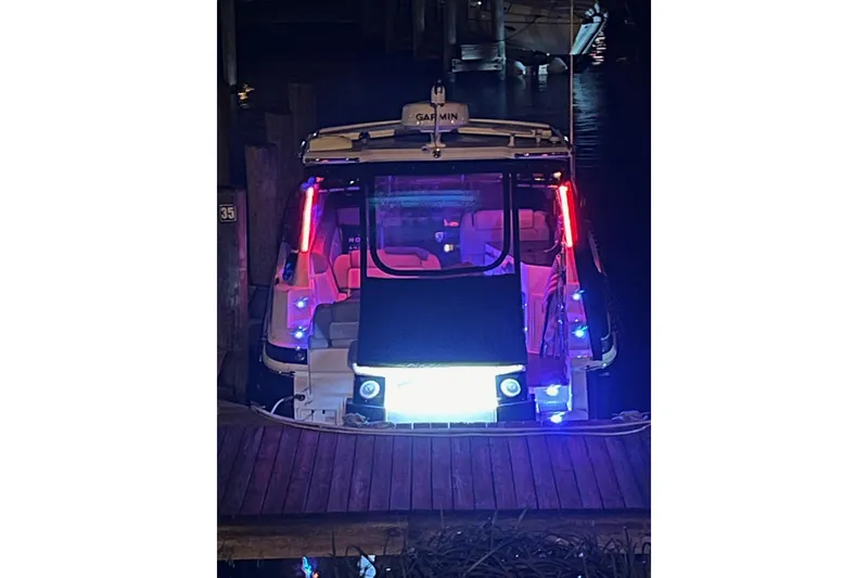 Slide: The Image of 2014 Regal 35 Sport Coupe boat docked, rear view with "Dalia" and "Chicago" signage. - 12