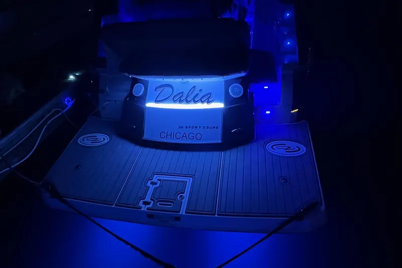 Slide: The Image of 2014 Regal 35 Sport Coupe with vibrant LED lights at night dock. - 13