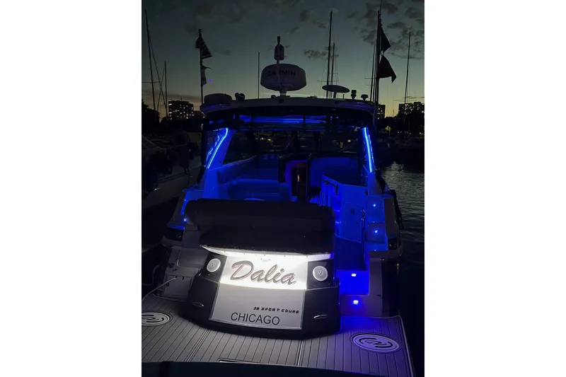 Slide: The Image of 2014 Regal 35 Sport Coupe boat with blue LED lights at night. - 14