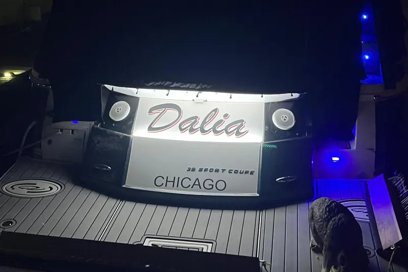 Slide: The Image of 2014 Regal 35 Sport Coupe boat with blue LED lights at night in Chicago marina. - 15