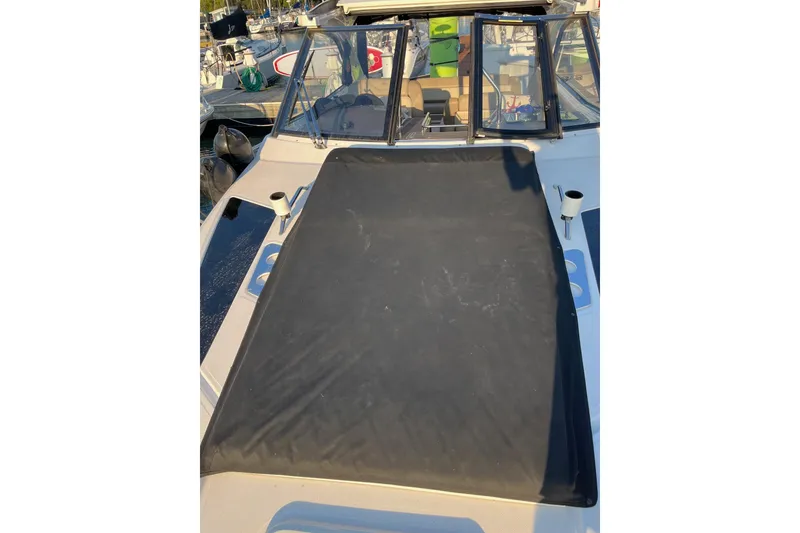 Slide: The Image of 2014 Regal 35 Sport Coupe docked at marina with sailboats in background. - 21