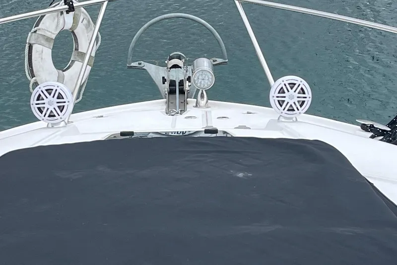 Slide: The Image of 2014 Regal 35 Sport Coupe boat with black sunpad cover on deck. - 22