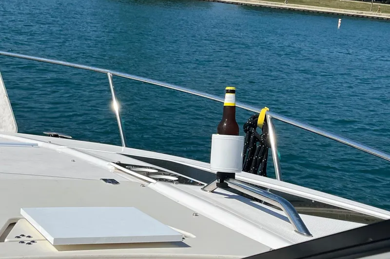 Slide: The Image of 2014 Regal 35 Sport Coupe boat interior with sunlit marina background. - 27