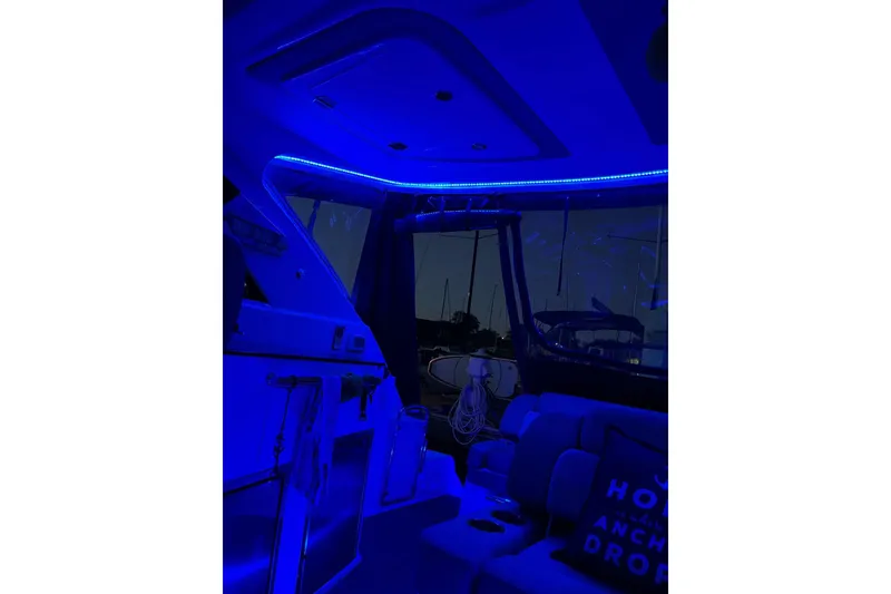 Slide: The Image of 2014 Regal 35 Sport Coupe boat with drink holder on deck, cruising on blue water. - 28