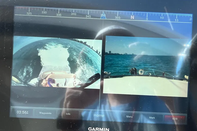 Slide: The Image of Nighttime marina view with sailboats and city skyline, captured from a 2014 Regal 35 Sport Coupe. - 36