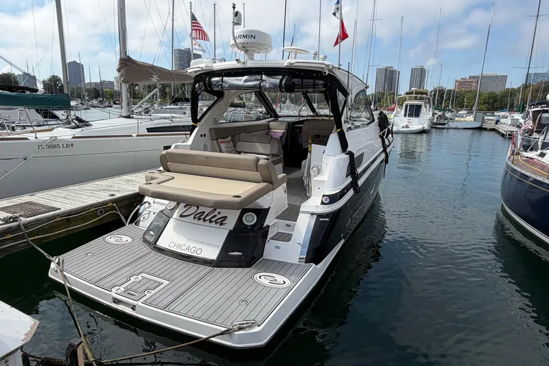 Slide: The Image of 2014 Regal 35 Sport Coupe docked, featuring sleek design and spacious seating. - 4
