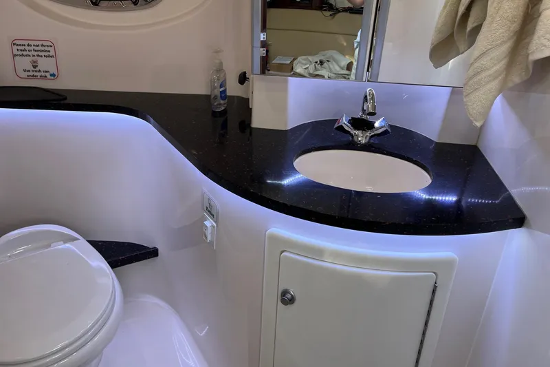 Slide: The Image of Control panel of 2014 Regal 35 Sport Coupe boat, featuring wood finish and multiple switches. - 55