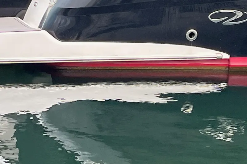 Slide: The Image of Control panel of a 2014 Regal 35 Sport Coupe boat, featuring various switches and indicators. - 58