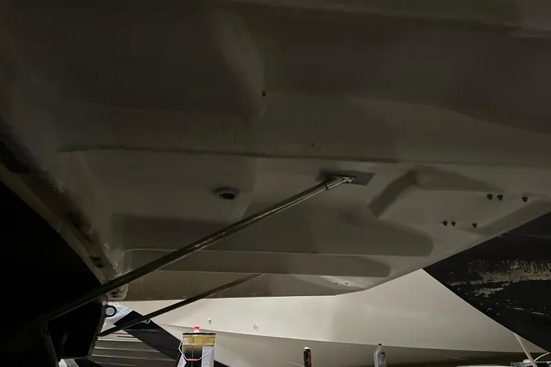 Slide: The Image of Hand inspecting electrical connections in 2014 Regal 35 Sport Coupe boat. - 64