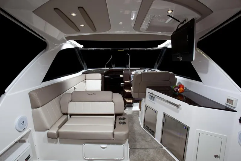 Slide: The Image of Hand inspecting electrical connections in 2014 Regal 35 Sport Coupe boat. - 74