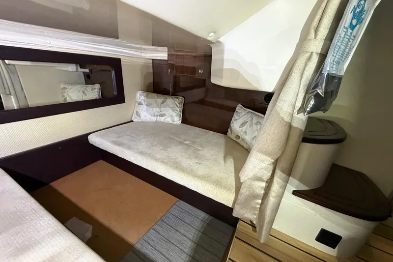 Slide: The Image of Interior cabin of 2014 Regal 35 Sport Coupe with cushioned seating and decorative pillows. - 87