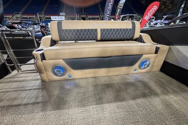 Slide: The Image of 2026 Barletta Lusso 25UC boat interior with beige seating and blue speakers. - 10