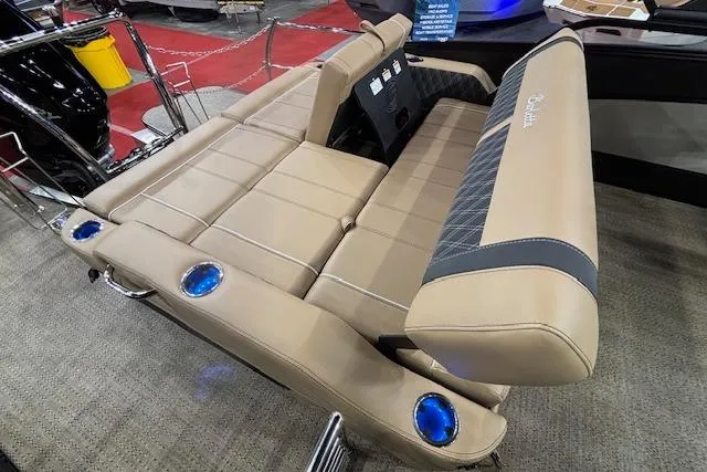 Slide: The Image of 2026 Barletta Lusso 25UC boat interior with luxurious beige seating and blue cup holders. - 12