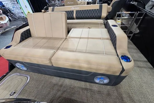 Slide: The Image of Luxurious seating on 2026 Barletta Lusso 25UC pontoon boat with beige upholstery and cup holders. - 16