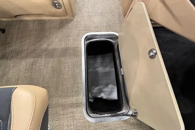 Slide: The Image of 2026 Barletta Lusso 25UC interior storage compartment with beige upholstery and carpet flooring. - 26