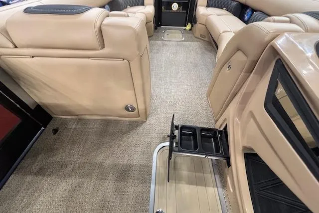 Slide: The Image of 2026 Barletta Lusso 25UC interior with beige seating and carpeted flooring. - 27