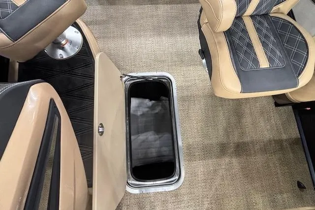 Slide: The Image of 2026 Barletta Lusso 25UC boat interior with open storage compartment and cushioned seating. - 7