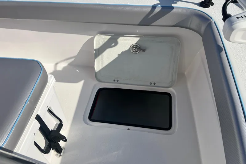 Slide: The Image of 2026 Shallow Stalker The Boss boat interior with storage compartment and cushioned seating. - 14