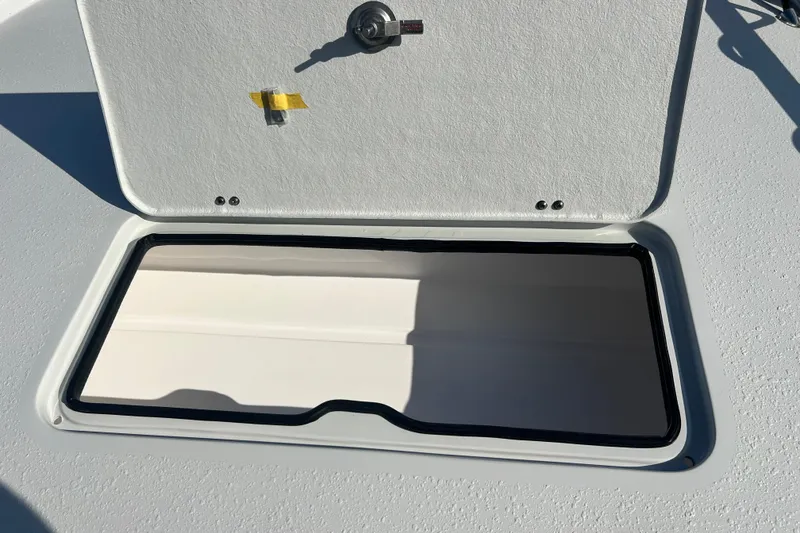 Slide: The Image of Open hatch on 2026 Shallow Stalker The Boss boat, showcasing interior storage space. - 16