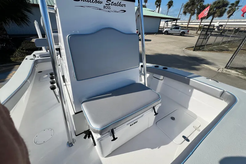 Slide: The Image of Shallow Stalker The Boss 2026 boat interior with seating and storage, dockside view. - 19
