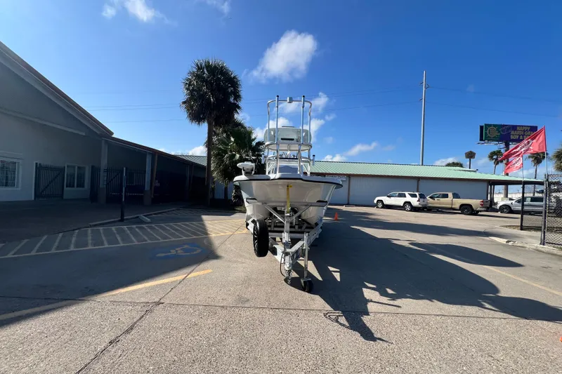 Slide: The Image of 2026 Shallow Stalker "The Boss" boat on trailer in sunny parking lot. - 2