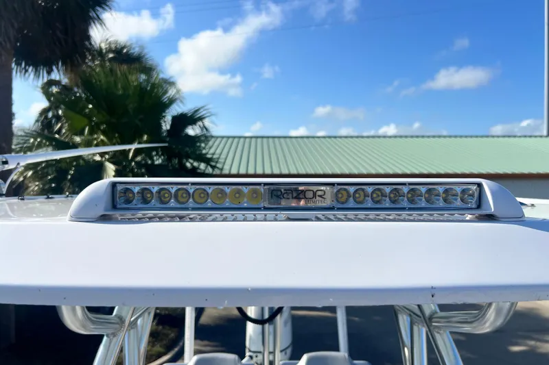 Slide: The Image of 2026 Shallow Stalker The Boss boat with Razor light bar under clear blue sky. - 24