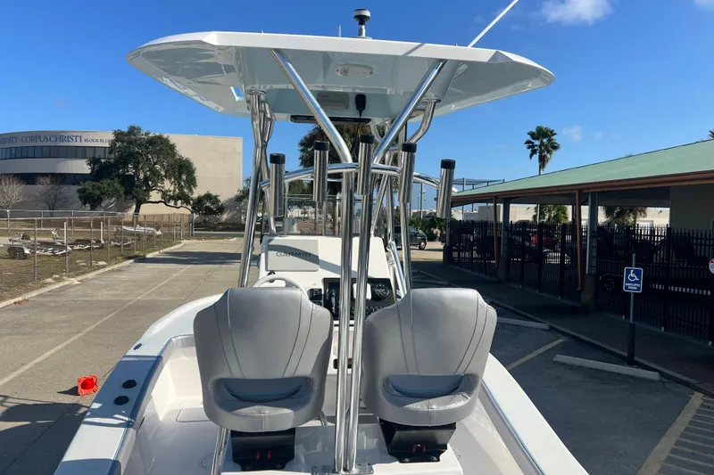 Slide: The Image of 2026 Shallow Stalker "The Boss" boat with dual seats and canopy in a parking area. - 27