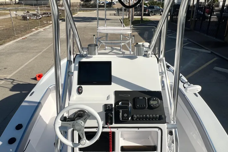 Slide: The Image of 2026 Shallow Stalker The Boss boat dashboard with steering wheel and control panel. - 9