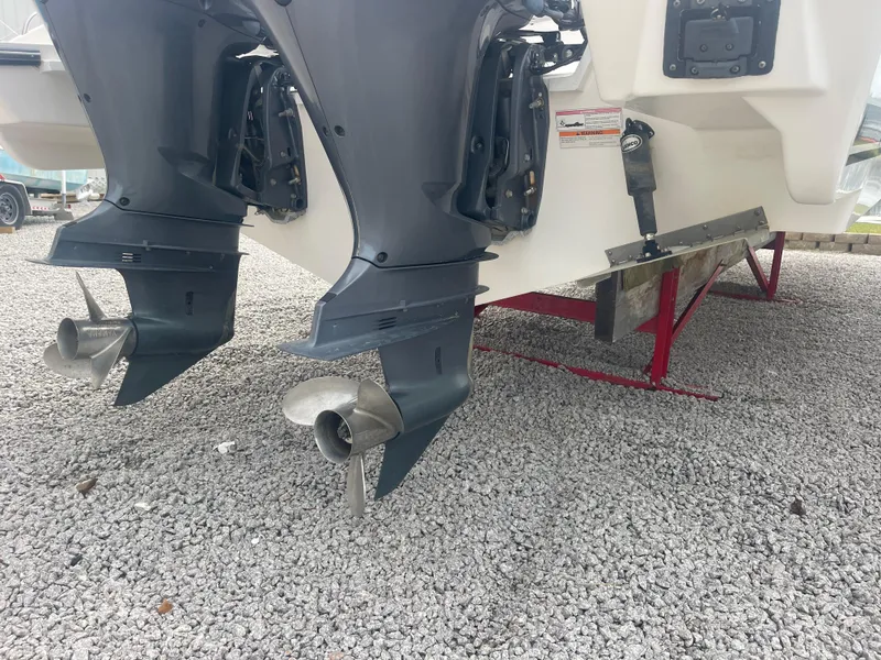 Slide: The Image of 2016 Pursuit DC 325 Dual Console boat engines on gravel. - 10