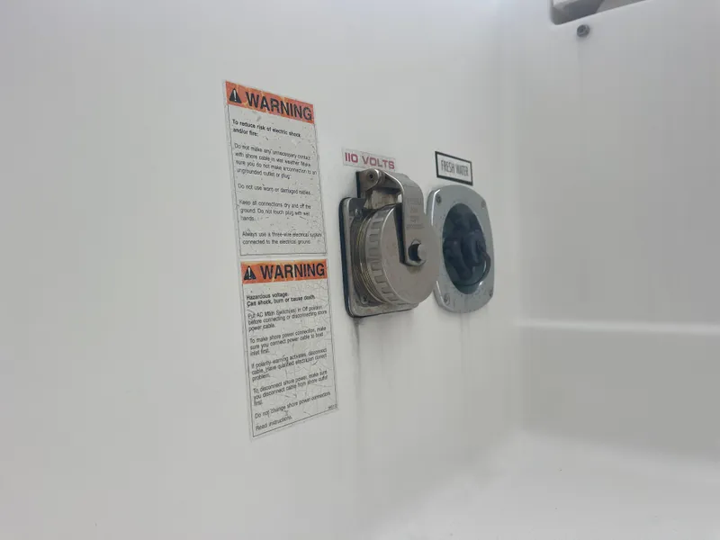 Slide: The Image of Warning labels and ports on Pursuit DC 325 boat, 2016 model. - 15