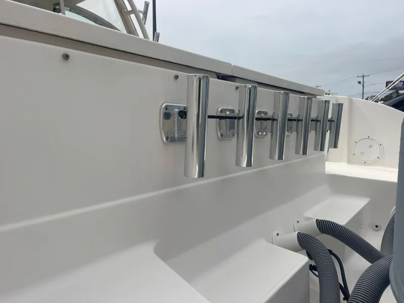 Slide: The Image of Rod holders on a 2016 Pursuit DC 325 Dual Console boat. - 16