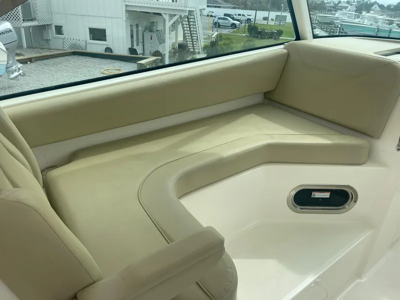 Slide: The Image of Interior of 2016 Pursuit DC 325 Dual Console with beige seating. - 20