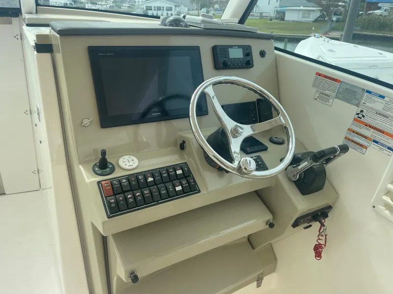 Slide: The Image of Helm of a 2016 Pursuit DC 325 Dual Console boat. - 21