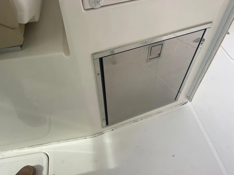 Slide: The Image of Interior of 2016 Pursuit DC 325 Dual Console with storage compartment. - 24