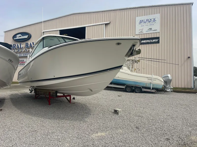 Slide: The Image of 2016 Pursuit DC 325 Dual Console boat on gravel lot. - 3