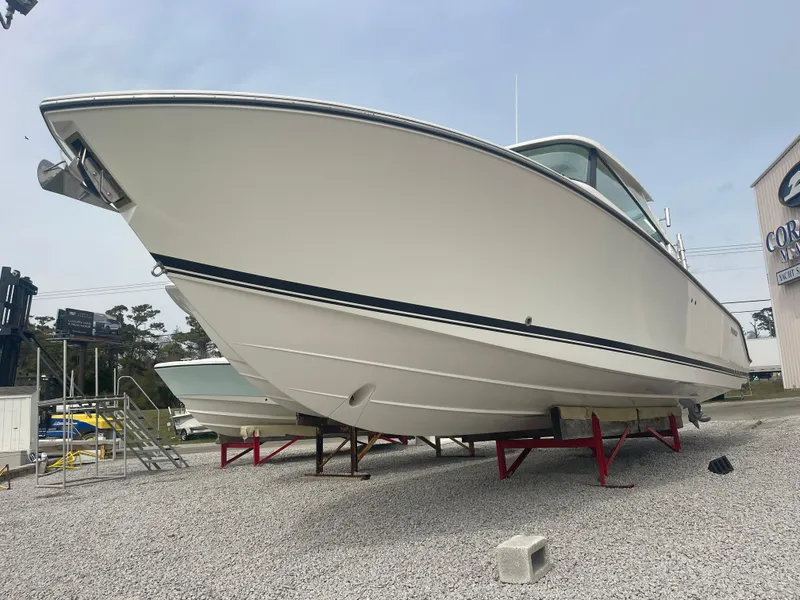 Slide: The Image of 2016 Pursuit DC 325 Dual Console on outdoor stands. - 5