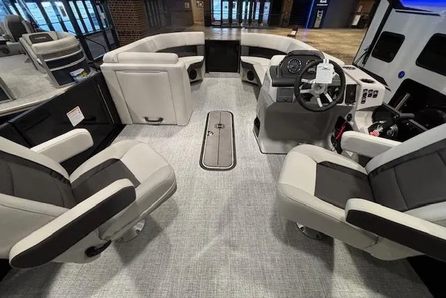 Slide: The Image of 2026 Harris Cruiser 230 boat interior with modern seating and steering console. - 23
