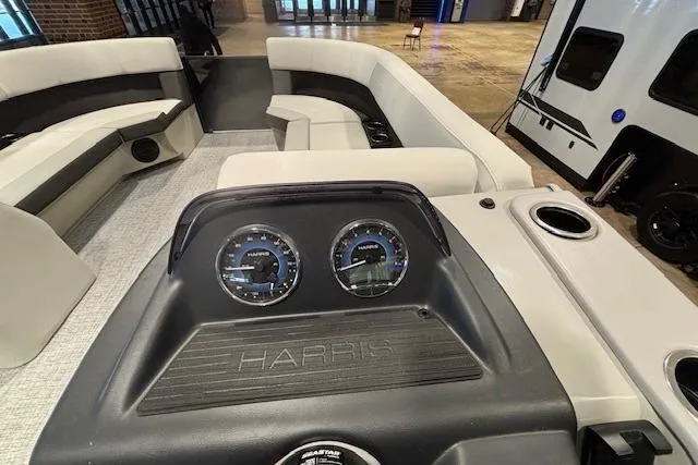 Slide: The Image of 2026 Harris Cruiser 230 boat interior with dashboard and seating area. - 26