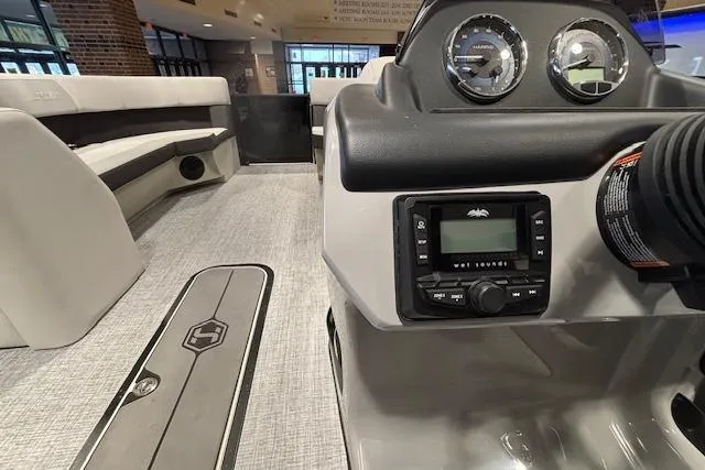 Slide: The Image of 2026 Harris Cruiser 230 interior with modern dashboard and seating. - 27