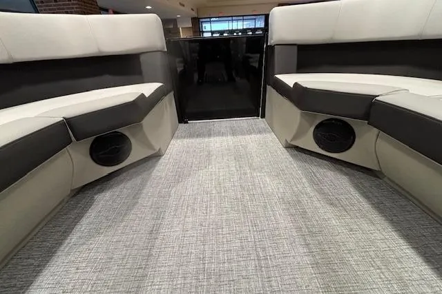 Slide: The Image of Interior of 2026 Harris Cruiser 230 boat with modern seating and carpeted flooring. - 31