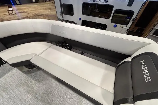 Slide: The Image of 2026 Harris Cruiser 230 boat interior with plush seating and cup holders. - 32