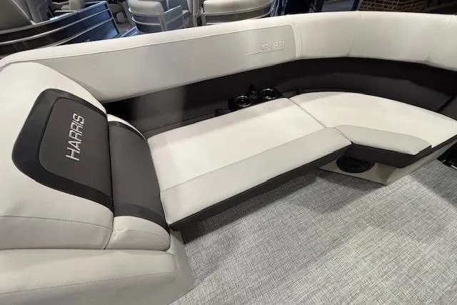 Slide: The Image of 2026 Harris Cruiser 230 boat interior with plush seating and cup holders. - 34